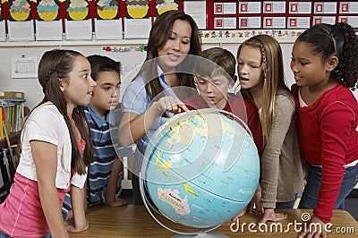 Teacher Explaining Globe To Students
