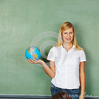 Teacher with globe in school class