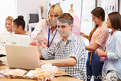 Teacher Helping College Students Studying Fashion And Design