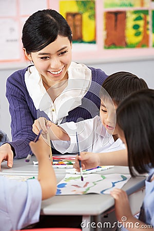 Teacher Helping Students During Art Class