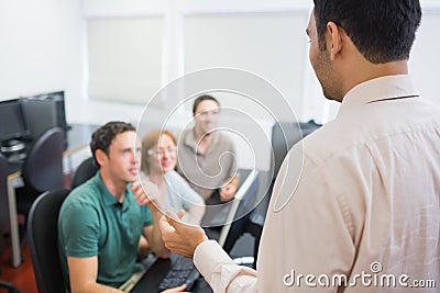 Teacher and mature students in computer room