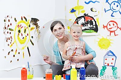 Teacher And Pupil In Pre School Art Class