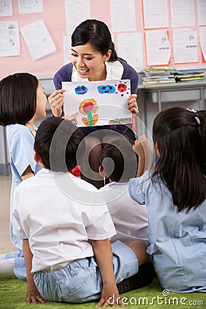 Teacher Showing Painting To Students