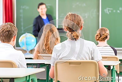 Teacher teaching or educate at the board a class in school