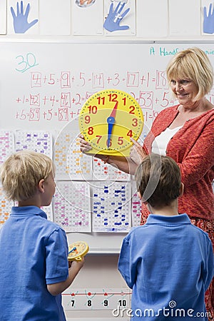 Teacher Teaching Kids To Tell Time