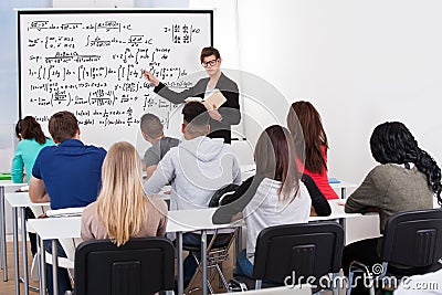 Teacher teaching math formulas to college students