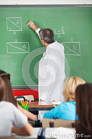 Teacher Writing On Greenboard While Teaching
