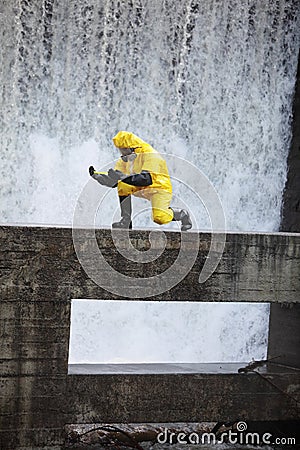 Technician examining toxic substance in contaminated area