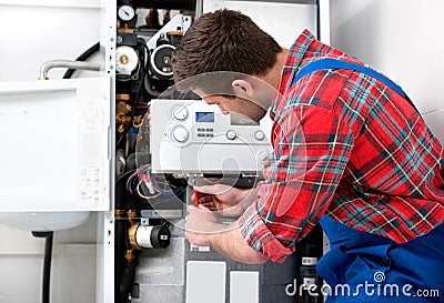 Technician servicing heating boiler