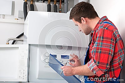 Technician servicing heating boiler