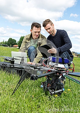 Technicians Discussing Over Digital Tablet By UAV
