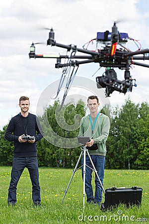 Technicians Flying UAV Helicopter in Park