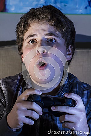 Technology. boy with joystick playing computer game at home.