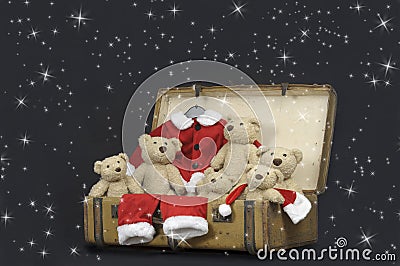 Teddy bears and santa outfit in an old vintage suitcase