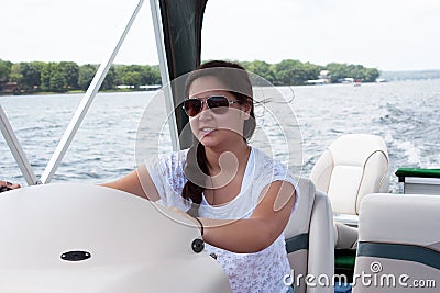 Teen Girl Driving a Boat