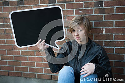 Teen girl holds black sign