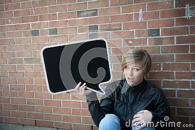 Teen girl holds black sign