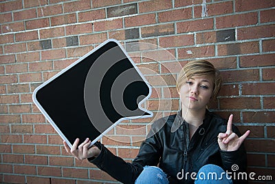 Teen girl holds black sign