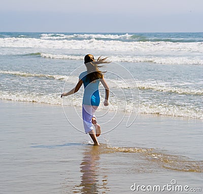 Teen Girl Running in the Surf