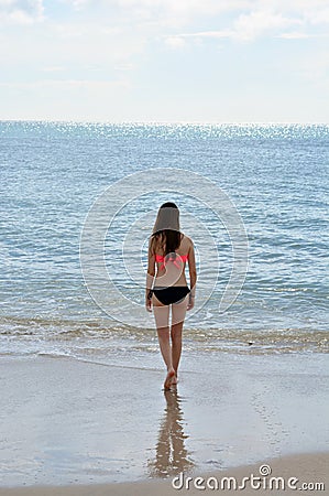 Teen Girl Walking Toward Ocean