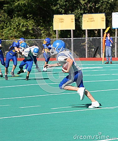 Teen Youth Football Player Running with the Ball