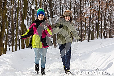 Teenage boy and girl running outdoor in winter park