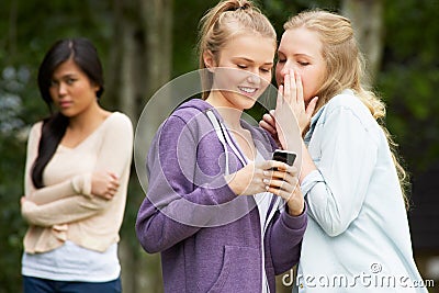 Teenage Girl Being Bullied By Text Message On Mobile Phone