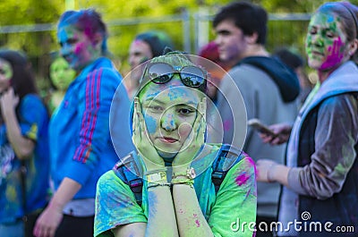 Teenage girl covered in green powder