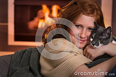 Teenage girl loving cat at home