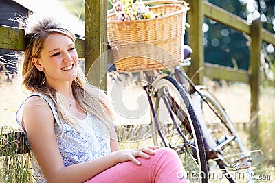 Teenage Girl Relaxing On Cycle Ride In Countryside