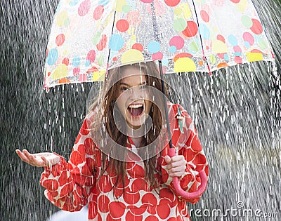 Teenage Girl Sheltering From Rain Beneath Umbrella