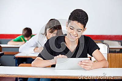 Teenage Schoolboy Using Digital Tablet At Desk