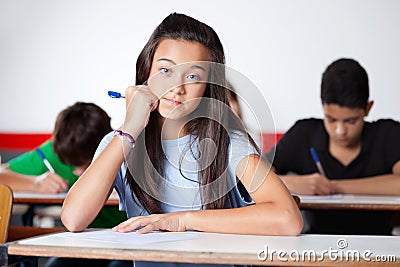 Teenage Schoolgirl Sitting At Desk