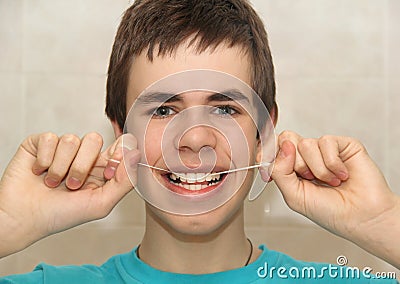 Teenager with dental floss