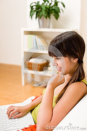 Teenager girl relax home - happy with laptop