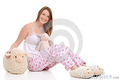 Teenager in pajamas with toy sheep