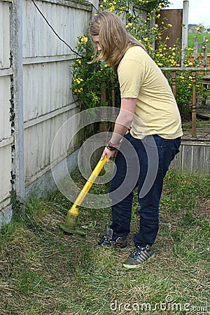 Teenager Working With Garden Trimmer