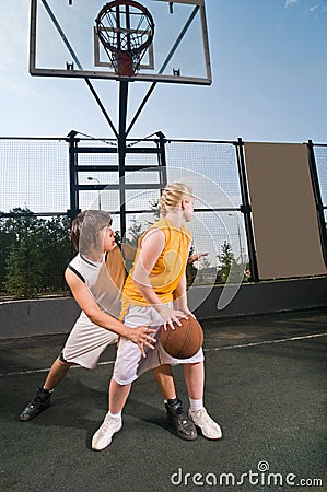 Teenagers playing basketball