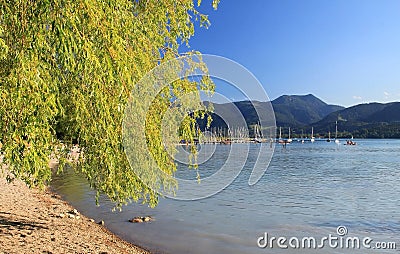 Tegernsee lake shore with view to mountains and boats