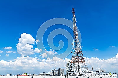 Telecommunication tower with a cloud and bluesky. Used to transmit television. Antenna with blue sky in the city