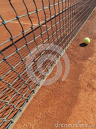 Tennis ball on clay court