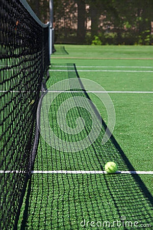 Tennis ball on a court neat net