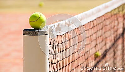 Tennis balls on the court near tennis nets