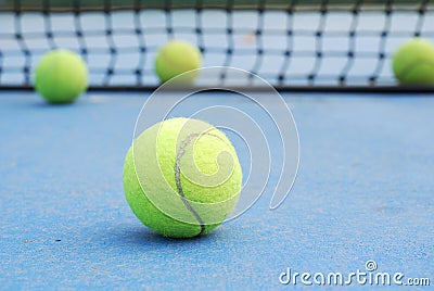 Tennis balls on court with net
