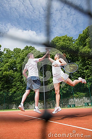 Tennis doubles team celebrating a win