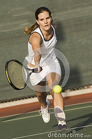 Tennis Player Reaching To Hit Ball