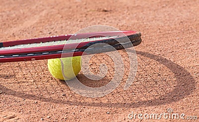 Tennis racket and balls on the clay court
