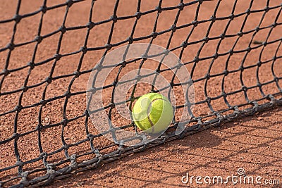 Tennis racket and balls on the clay court