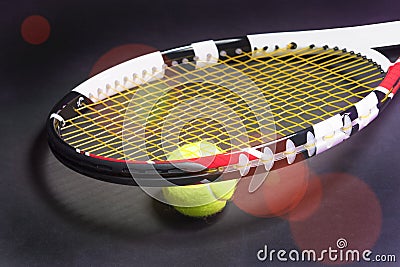 Tennis Racket with Tennis Ball on Black