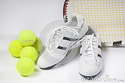 Tennis sports Concept: Raquet, Balls and Sneakers against white